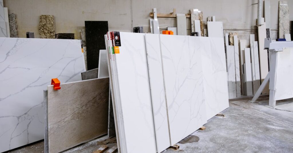 Wide view of granite and marble slabs neatly arranged in a factory setting, showcasing variety and texture.